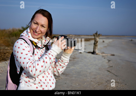 Young Woman Posing with Camera at Folly Beach in Charleston County, South Carolina Stock Photo