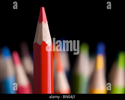 Sharp red pencil highlights over many other colored pencils.
