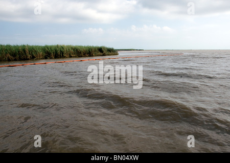 Protective boom surrounding marshes in Barataria Bay, LA, during BP oil spill Stock Photo