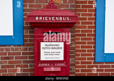 Tulip time festival Dutch Holland Michigan in USA US an authentic historic Dutch post mailbox on red bricks wall background in Windmill Island hi-res Stock Photo