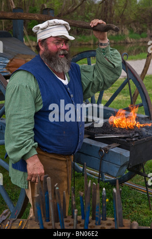 Tulip time festival Dutch Holland Michigan in USA .XVIII century blacksmith in dressed traditional costume at work during a trade fair hi-res Stock Photo