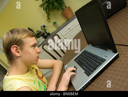 Young boy who has mild autism using laptop computer, Sutton, UK. Stock Photo