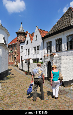 Tourists visiting the Saint Elisabeth Beguinage with its small houses built in the 17th century, Kortrijk, Belgium Stock Photo