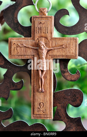 Wooden crucifix and rusty metal pattern background. Stock Photo