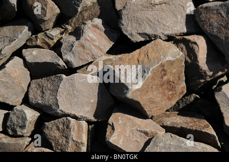 Brown clunky stones abstract background. These rocks are rough, not round Stock Photo