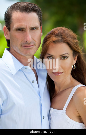 Outdoor natural light portrait shot of an attractive, successful and happy middle aged man and woman couple in their thirties Stock Photo