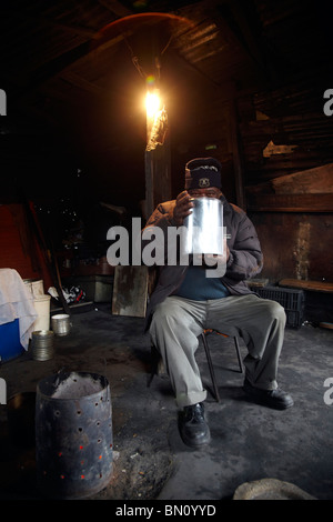 black man drinking home brew in Shebeen She Been Stock Photo