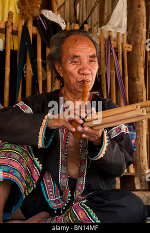 Man playing a type of flute at Baan Tong Luang, village of Hmong people in rural Chiang Mai province, Thailand. Stock Photo