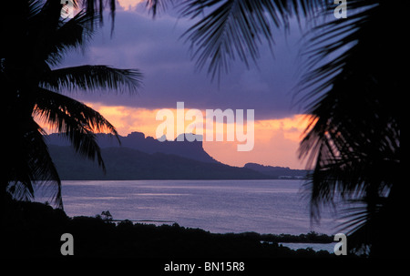 Sokehs Rock, lagoon and palm trees at sunset from the restaurant and bar at The Village Hotel; Pohnpei, Micronesia. Stock Photo