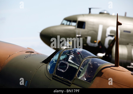 A Spitfire pictured in front of a DC-3 transport aircraft from World War Two at the Cotswold Airshow in Kemble in 2010 Stock Photo