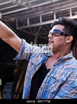 Popular English/British Bhangra singer, Jaz Dhami, at Glasgow Mela 2010 in Kelvingrove Park. Audience reflected in sunglasses. Stock Photo