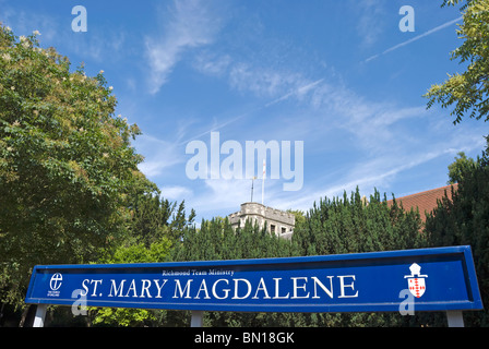 name sign outside st mary magdalene church, richmond upon thames, surrey, england, with church tower visible in background Stock Photo