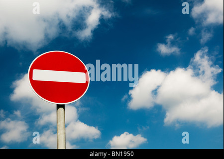 No entry road signpost against a cloudy blue sky. UK Stock Photo