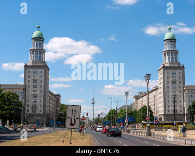 View of Frankfurter Tor historic landmark with TV Tower to rear on Karl Marx Allee in former East Berlin Germany Stock Photo