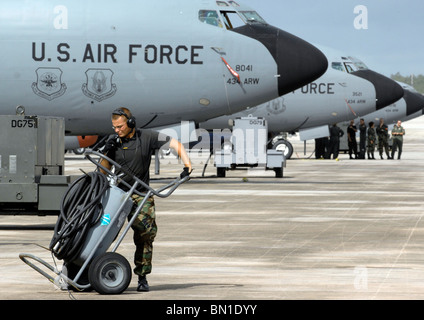 Senior Airman David Engelhardt, crew chief moves a fire bottle April 29 at Andersen Air Force Base, Guam. Stock Photo