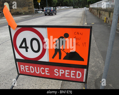 Road work sign with speed limit and graffiti Stock Photo