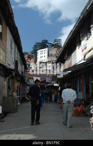 Pedestrians walk along the lower bazaar in the hill town of Shimla in Himachal Pradesh. Stock Photo