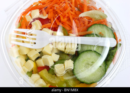 Packed, fresh prepared salads in a plastic box, from a cooler in a supermarket. Stock Photo