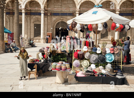 Egypt child; A young egyptian boy in traditional costume selling goods from his stall, Muhammad Ali mosque, Cairo, Egypt Africa Stock Photo