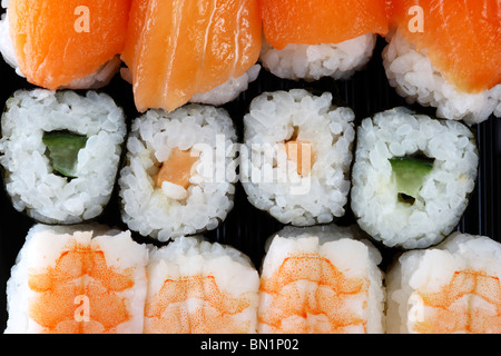 Different sushi and sashimi pieces in a box, for take away, in a supermarket. Stock Photo