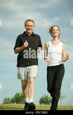 Mature couple jogging together Stock Photo
