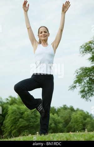 Mature woman exercising in park Stock Photo