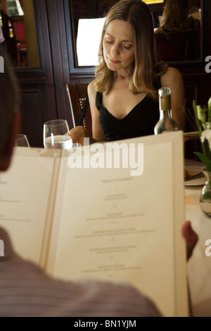 Couple reading menus in restaurant Stock Photo