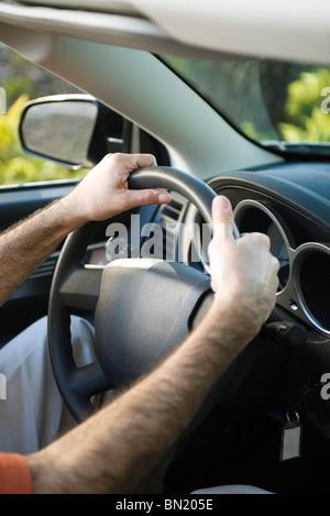 Driving car with both hands on the steering wheel Stock Photo