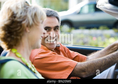 Mature couple out for drive together, man smiling at wife Stock Photo