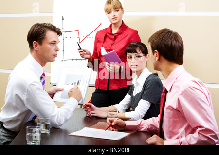 Image of smart teacher looking at students while explaining new topic Stock Photo