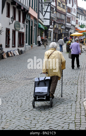 Elderly woman shopper pull trolley Bad Munstereifel Germany Deutschland Europe Stock Photo