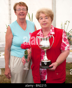 Two women with trophy for growing roses, flower show Limerick Stock Photo