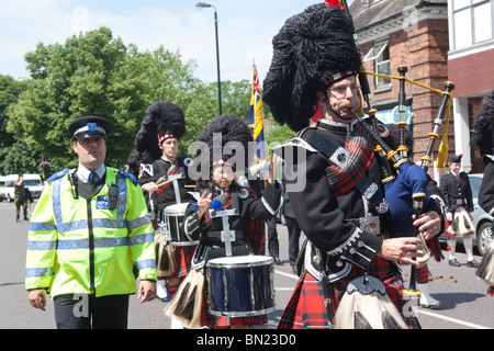 Epping Forest Pipe Band leads the North East London “Armed Forces Day” Parade, Station Road, Chingford, London Borough of Waltha Stock Photo