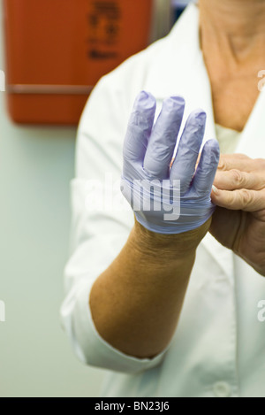 Taking off disposable latex glove Stock Photo