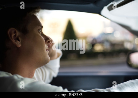 Man driving, lost in thought Stock Photo