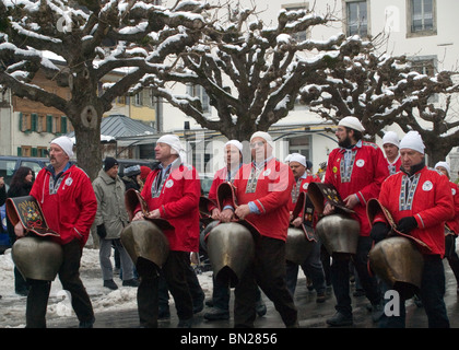 Nostalgia: Alpine bell ringers clinging huge cow bells on swiss parade for New Year Stock Photo