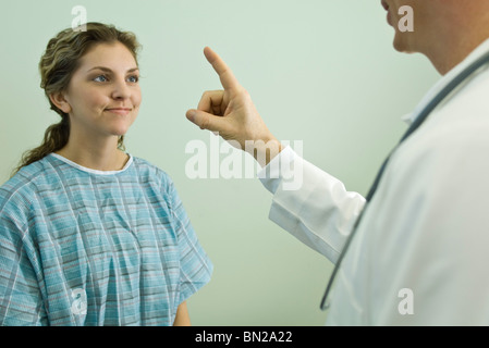 Doctor testing patient's ocular responsiveness Stock Photo