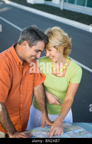 Mature couple looking at road map together planning route for road trip Stock Photo