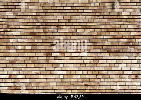 Cedar shingles on a roof. Wooden roofing tiles Stock Photo