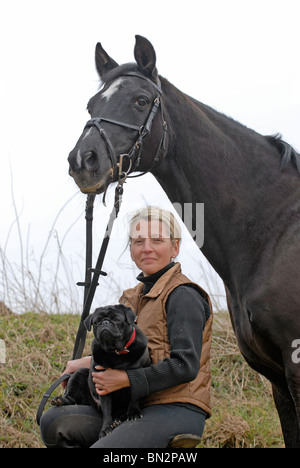 woman with horse and dog Stock Photo