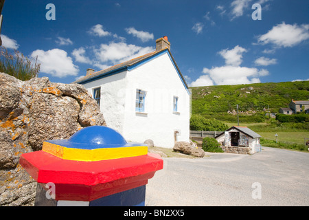 A house at Porthgwarra and a collecting box for the RNLI, on the Cornish coast near Lands End, UK. Stock Photo