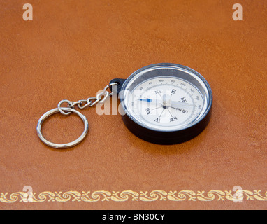 Compass on old leather desk Stock Photo
