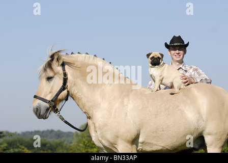 man with horse and pug Stock Photo