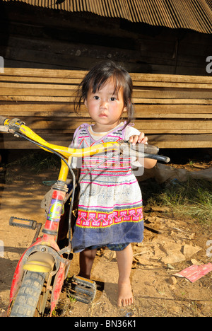 Portrait of a girl holding her bike in a Hmong village, Mae Hong Son, Northern Thailand, Asia Stock Photo