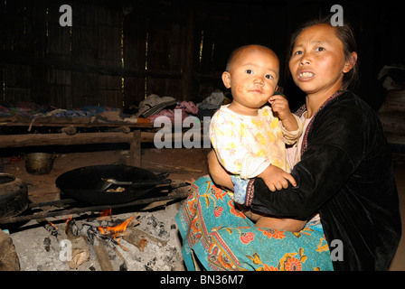 Woman with her baby in her house in a Hmong village, Mae Hong Son, Northern Thailand, Asia Stock Photo