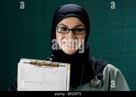 Middle Eastern doctor holding medical chart Stock Photo