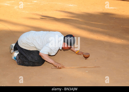 Hmong people playing top spinning during a tournament  in Ban Pha-nok-kok village, near Chiang Mai, Thailand, Asia Stock Photo