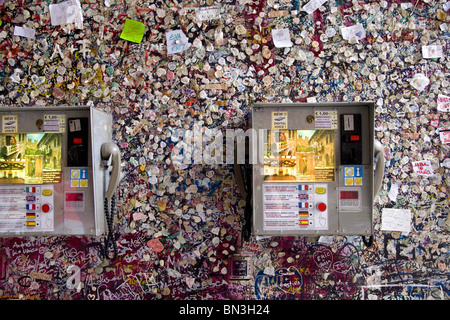 Two telephones on a facade covered with memos and chewing gums (Casa di Giulietta), Verona, Italy Stock Photo