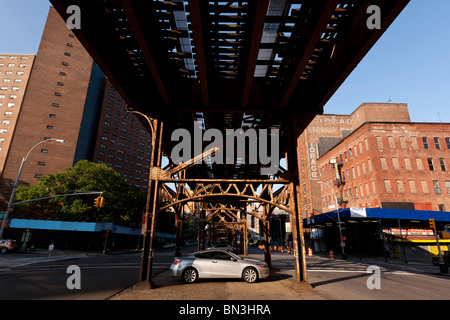 Under the MTA elevated subway bridge at Broadway and 133rd street in New York USA Stock Photo