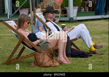 Man and woman sat relaxing in deckchairs at Hay Festival 2010 Hay on Wye Powys Wales UK Stock Photo
